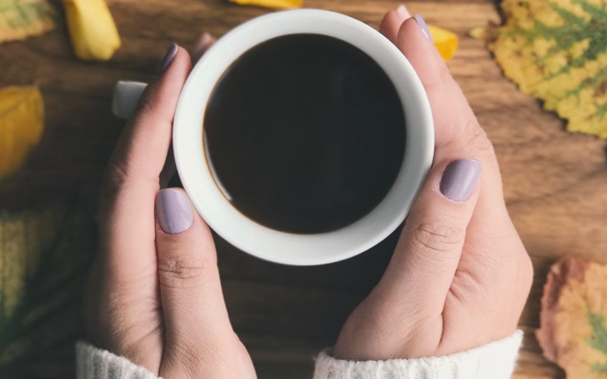 hands holding cup of coffee