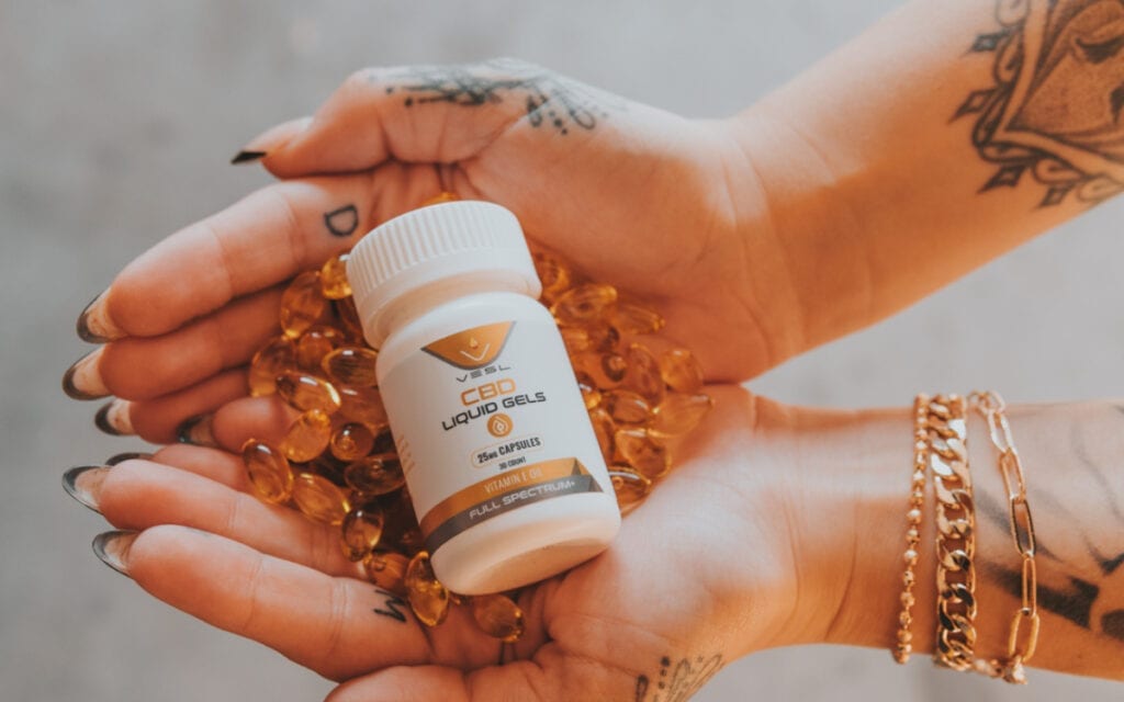 CBD role in women's health, CBD capsules on hand