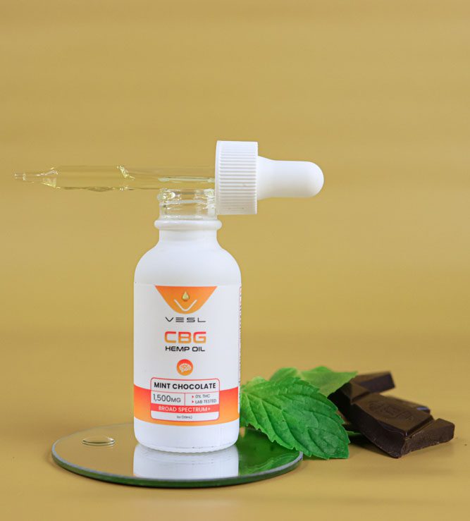 CBG hemp oil mint chocolate flavor 1500mg on the display stand with leaves and chocolates